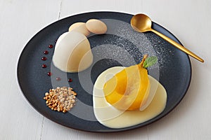 Traditional Italian dessert, panna cotta with poached pears and creme Anglaise