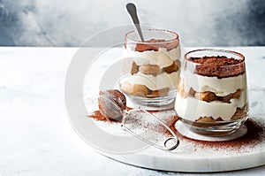 Traditional Italian dessert tiramisu in a glass.