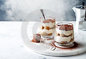 Traditional Italian dessert tiramisu in a glass. photo