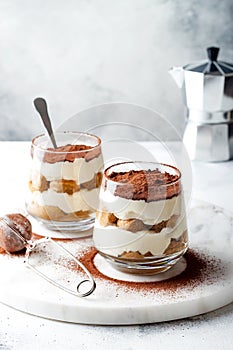 Traditional Italian dessert tiramisu in a glass.