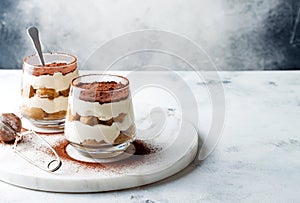 Traditional Italian dessert tiramisu in a glass.