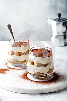 Traditional Italian dessert tiramisu in a glass.