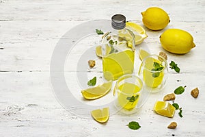 Traditional Italian digestif: liqueur Limoncello with lemons and fragrant mint leaves