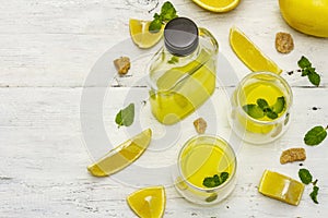 Traditional Italian digestif: liqueur Limoncello with lemons and fragrant mint leaves