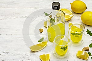 Traditional Italian digestif: liqueur Limoncello with lemons and fragrant mint leaves