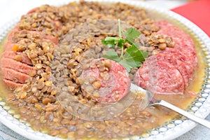 Traditional italian disch for last day of year pork sausage cotechino whit lentils