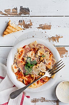 Traditional Italian dish, chowder, pottage, pasta e ceci served in old plate on old wooden background.