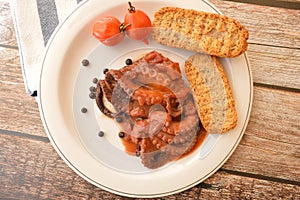 Traditional italian dish octopus luciana with tomato photo
