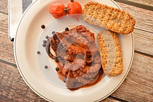 Traditional italian dish octopus luciana with tomato photo