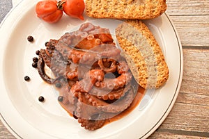 Traditional italian dish octopus luciana with tomato photo