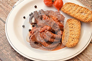 Traditional italian dish octopus luciana with tomato photo