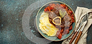 Traditional Italian dish Ossobuco all Milanese made with cut veal shank meat with vegetable tomato sauce served with