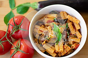 Traditional italian dish: pasta alla norma with tomatoes, eggplant, garlic, basil and ricotta cheese