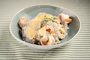 Traditional Italian dish risotto with seafood served on a plate in a restaurant