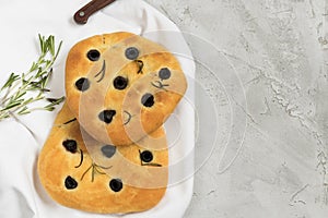 Traditional Italian Focaccia with black olives and rosemary - homemade flat bread focaccia