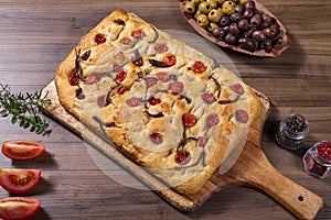 Traditional Italian Focaccia with cherry tomatoes, black olives and rosemary