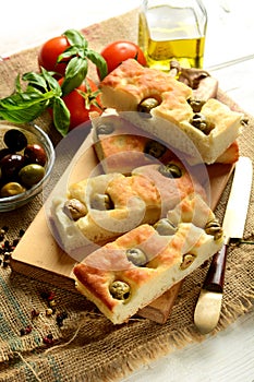 Traditional Italian focaccia with olives on the table