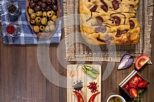 Traditional Italian Focaccia with pepperoni, cherry tomatoes, black olives, rosemary ando onion - homemade flat bread focaccia photo