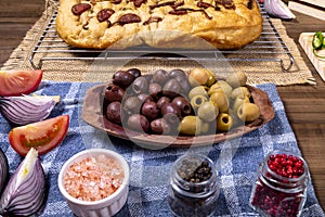 Traditional Italian Focaccia with pepperoni, cherry tomatoes, black olives, rosemary ando onion - homemade flat bread focaccia photo