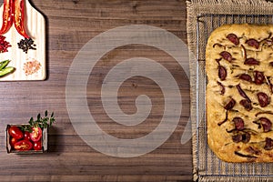 Traditional Italian Focaccia with pepperoni, cherry tomatoes, black olives, rosemary ando onion - homemade flat bread focaccia photo