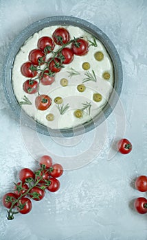 Traditional italian focaccia with tomatoes, olives and rosemary. The process of making focaccia. Italian Cuisine . Space for text