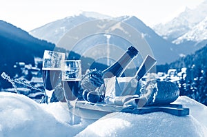 Traditional Italian food and drink outdoor at the ski resort. Romantic alpine picnic with mountains background