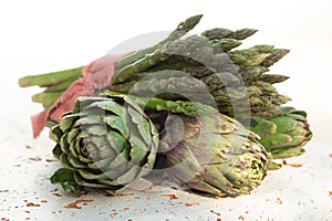 Traditional Italian food, fresh sprouts on Italian green asparagus vegetable and artichoke buds, new harvest on organic farm