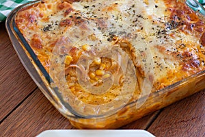 Traditional italian lasagna with cheese. On a wooden background