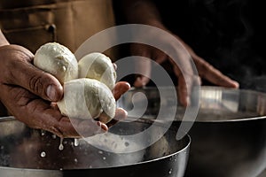 Traditional Italian mozzarella in hand. Cheesemaker, showing freshly made mozzarella