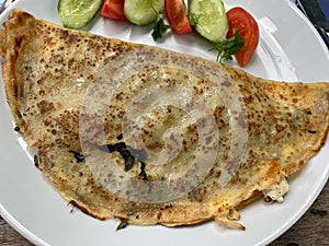 Traditional Italian pancakes crepes with spinach, ricotta and salad
