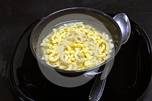 Traditional italian pasta in broth passatelli