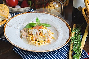 Traditional Italian pasta Carbonara with salmon and red caviar on a plate