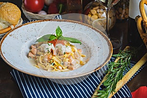 Traditional Italian pasta Carbonara with salmon and red caviar on a plate