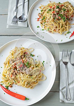 Italian pasta dish aglio e olio. Tagliatelle noodles with olive oil, garlic, parsley and chili peppers.