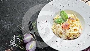 Traditional Italian pasta dish, spaghetti carbonara with yolk, parmesan cheese on a plate. photo