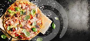 Traditional italian pizza on dark table photo