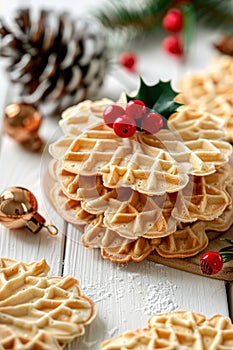 Traditional Italian pizzelle waffle cookies on white wooden background