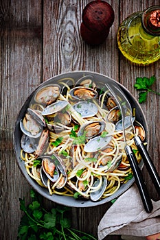 Traditional italian seafood pasta with clams Spaghetti alle Vongole in the pan photo