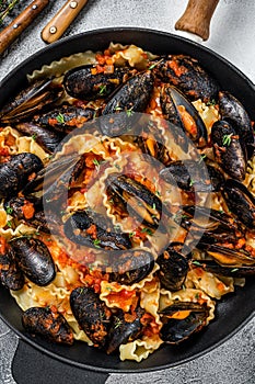 Traditional italian seafood pasta with mussels, Spaghetti and tomato sauce. White background. Top view