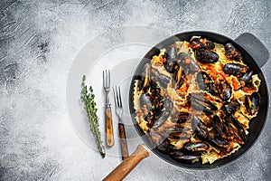 Traditional italian seafood pasta with mussels, Spaghetti and tomato sauce. White background. Top view. Copy space