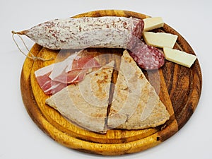 Traditional italian torta al testo and salami photo