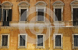 Traditional Italian windows with shutters in one of the houses o