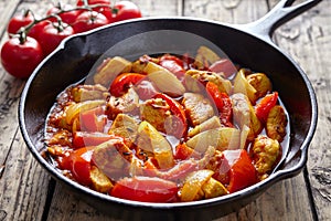 Traditional jalfrezi chicken Indian spicy meat and vegetables dish in cast iron pan photo