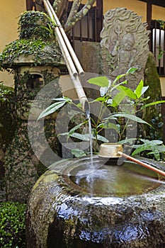 Traditional japanese bamboo purification fountain for purification at entrance of the Japanese temple.