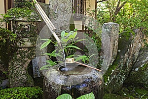 Traditional japanese bamboo purification fountain for purification at entrance of the Japanese temple.