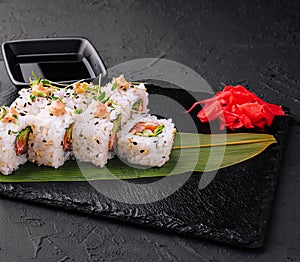 traditional japanese dish rolls with cucumbers and red salmon and onigiri soy sause