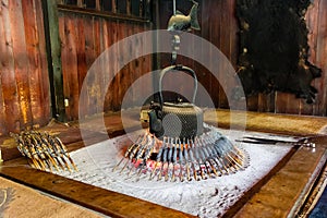 Traditional Japanese fireplace in a mountain hut cooking freshly caught Iwana (Grilled Char photo