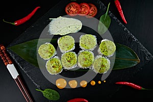 Traditional Japanese food - sushi, rolls and sauce on a black background. Top view.