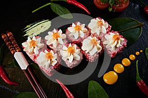 Traditional Japanese food - sushi, rolls and sauce on a black background. Top view.