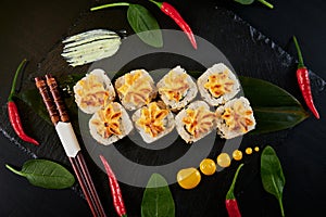 Traditional Japanese food - sushi, rolls and sauce on a black background. Top view.